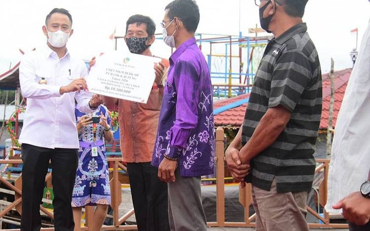Wali Kota Palangka Raya, Fairid Naparin saat menyalurkan bantuan CSR kepada para pelaku usaha di Dermaga Objek Wisata Air Hitam Kereng Bangkirai.
