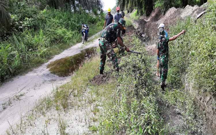 Satgas TMMD Kodim 1014 Pangkalan Bun Bersama Warga Kompak Bersihkan Parit Jalan