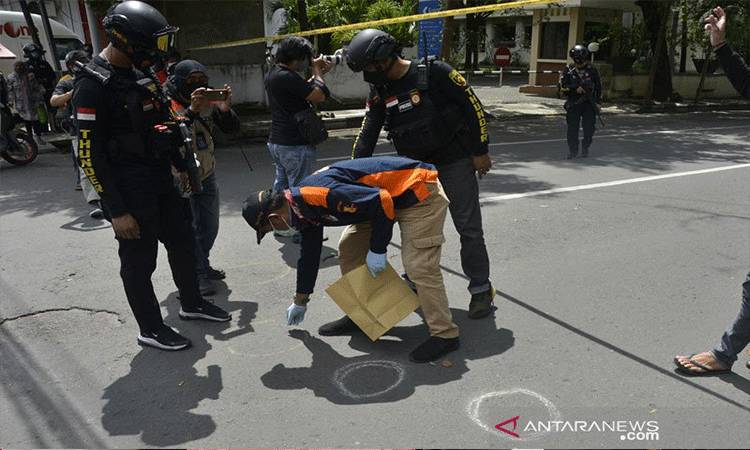 Aparat kepolisian melakukan pemeriksaan di sekitar sisa-sisa ledakan dugaan bom bunuh diri di depan Gereja Katolik Katedral, Makassar, Sulawesi Selatan, Ahad (28-3-2021). ANTARA FOTO/Abriawan Abhe/foc.