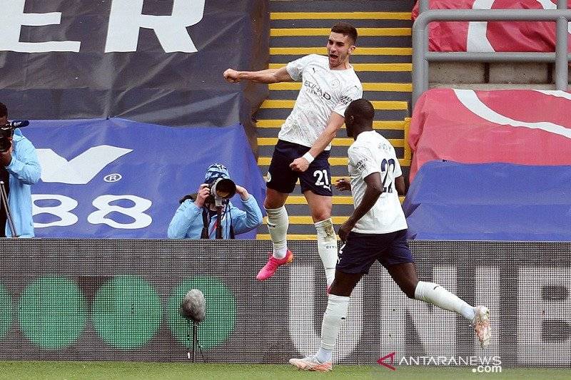 Gelandang Manchester City Ferran Torres (atas) melakukan selebrasi bersama Benjamin Mendy seusai mencetak gol ke gawang Crystal Palace dalam lanjutan Liga Inggris di Stadion Selhurst Park, London, Inggris, Sabtu (1/5/2021)