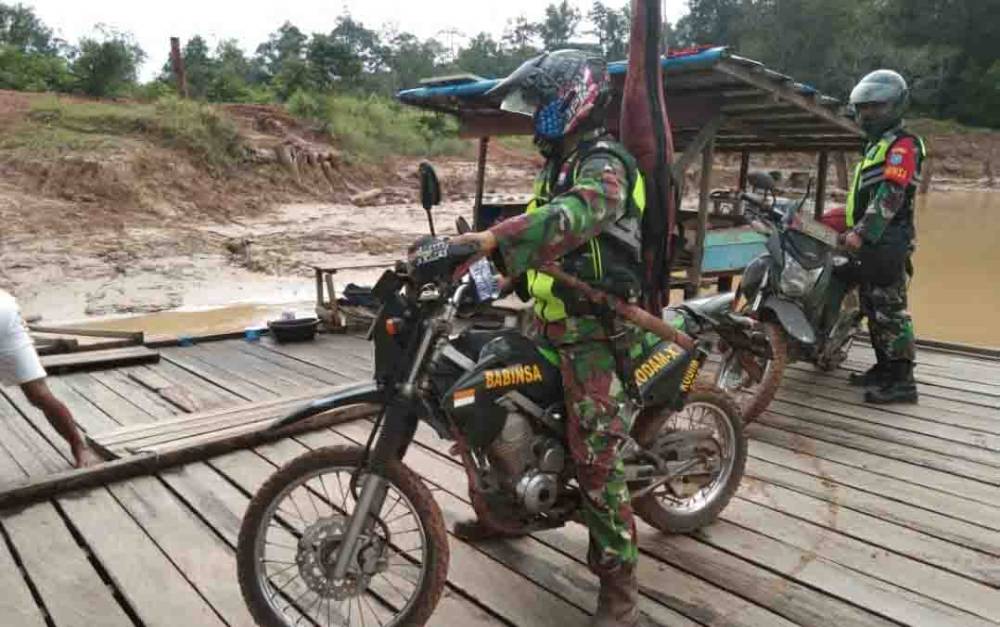 Babinsa Koramil Rungan saat menuju lokasi titik panas di Desa Bereng Malaka, Minggu, 6 Juni 2021.