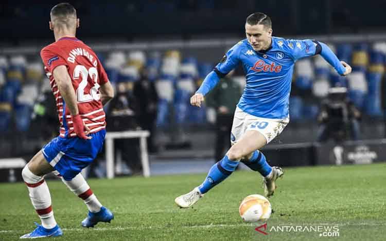 Gelandang Polandia Piotr Zielinski menbawa bola ketika pertandingan 32 besar Liga Europa antara Napoli vs Granada di Stadion Diego-Maradona, Naples, 25 Februari 2021. (ANTARA/AFP/FILIPPO MONTEFORTE)