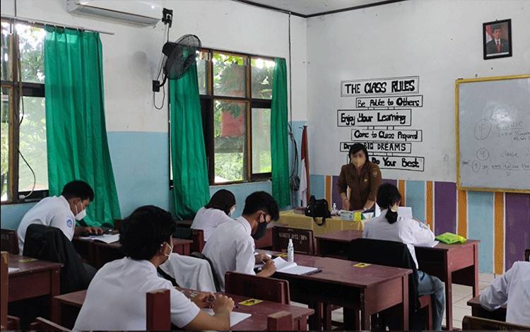 Proses belajar mengajar dengan sistem PTM terbatas di SMAN 2 Palangka Raya, Senin 11 Oktober 2021.