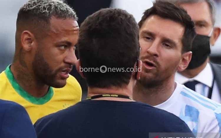 Pesepak bola timnas Argentina Lionel Messi (kanan) dan pesepak bola timnas Brasil Neymar (kiri) berdiskusi dengan sejumlah ofisial pertandingan saat laga kualifikasi Piala Dunia 2022 Zona Amerika Selatan antara Brasil dan Argentina dihentikan di Stadion Arena Corinthians, Sao Paulo, Brasil, Minggu (5/9/2021)