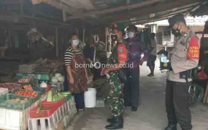 Babinsa Koramil 1014 - 05 Pangakalan Banteng Serda Muhaeni bersama Bhabinkamtibmas, saat operasi yustisi di Pasar Sumber Agung