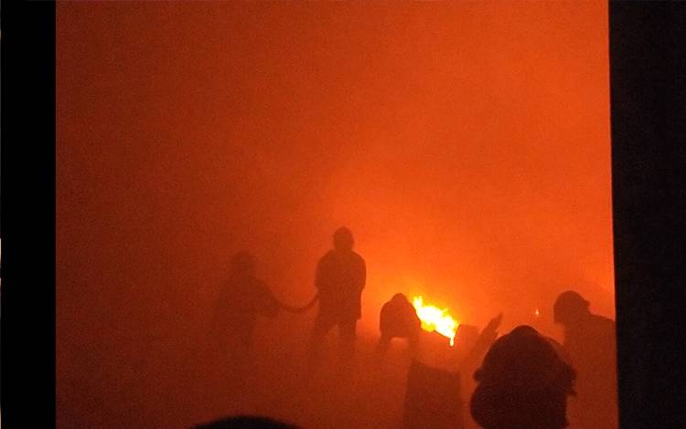 Sejumlah petugas pemadam kebakaran saat melakukan pemadaman terhadap gudang kelontongan yang terbakar.