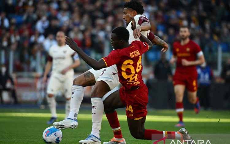 Gelandang Salernitana Ederson mempertahankan bola dari gangguan penyerang AS Roma Felix Afena-Gyan (kanan( pada pertandinga Liga Italia di Stadion Olimpico, Roma. (10/4/2022)