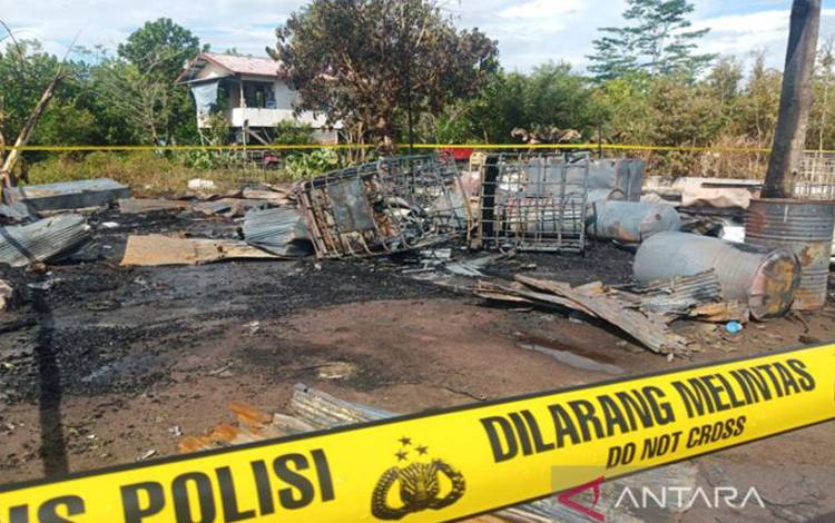 Lokasi diduga tempat penimbunan BBM yang terbakar di Jalan Alson Kota Palangka Raya, Kalimantan Tengah diberi garis polisi, setelah api yang berkobar di bangunan tersebut dapat dipadamkan petugas damkar, Selasa (12/7/2022). ANTARA/Adi Wibowo