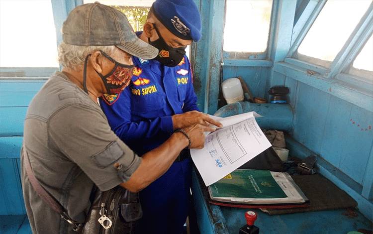 Personel Polairud Polres Seruyan, melakukan pengecekan terhadap dokumen kapal yang sandar di dermaga Kuala Pembuang (Foto : Polres Seruyan)