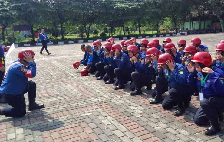 Anggota DPKP Kota Palangka Raya Christian Marchellius Tagas saat memimpin rekan-rekannya untuk menggunakan helm (Foto : DPKP Kota Palangka Raya)