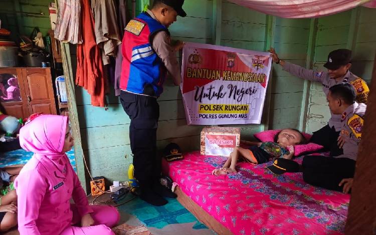 Polsek Rungan saat menyerahkan bantuan kepada remaja yang menderita hidrosefalus, Rabu, 27 September 2023. (FOTO: HUMAS POLRES GUMAS)