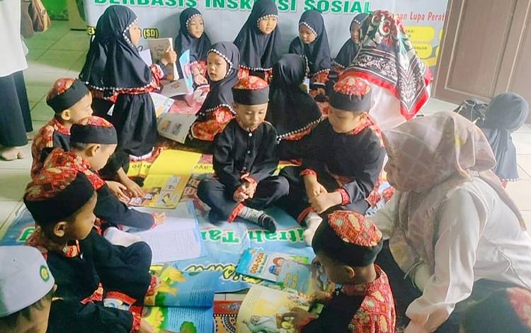 Murid TK Al Fitrah Tamiang Layang sedang membaca buku saat berkunjung ke perpustakaan daerah yang dikelola Dinas Perpustakaan dan Kearsipan Daerah Barito Timur, Rabu, 7 Februari 2024. (FOTO: IST)