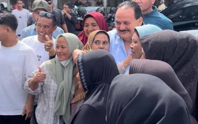 Presiden Direktur (Presdir) PT Nusa Halmahera Mineral (NHM), Haji Robert Nitiyudo Wachjo (gunakan kemeja biru-red) saat dikerumuni warga untuk menyalaminya, Minggu (14/7/2024). ANTARA/Abdul Fatah (Abdul Fatah)