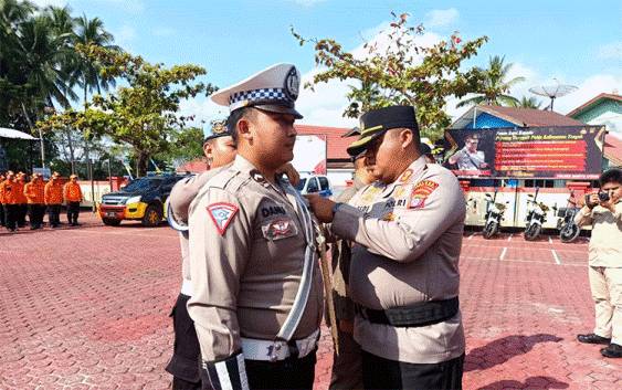 Kapolres Barito Utara, AKBP Gede Eka Yudharma sematkan pita kepada perwakilan anggota tanda dimulainya Operasi Patuh Telabang tahun 2024 di halaman Mapolres setempat, Senin 15 Juli 2024. (Foto: Dhani)