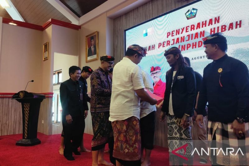 Bupati Bangli Sang Nyoman Sedana Arta menyerahkan naskah perjanjian hibah daerah (NPHD) ke para pengurus lembaga adat (Dok Humas)