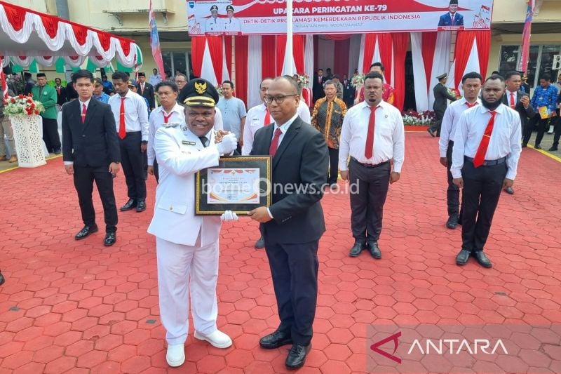 Bupati Manokwari Hermus Indou menyerahkan penghargaan kepada Kasat Reskrim Polresta Manokwari AKP Raja Putra Napitupulu dan jajarannya karena berhasil mengungkap peredaran senpi ilegal, Sabtu (17/8/2024). ANTARA/Ali Nur Ichsan