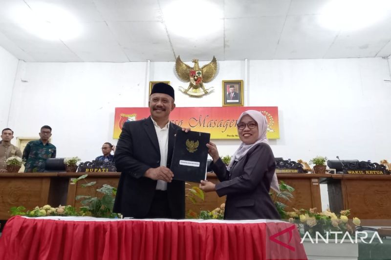 Sekretaris Daerah Kabupaten Sigi Nuim Hayat (kiri) usai menandatangani persetujuan dan penetapan peraturan daerah tentang pelaksanaan penghormatan, perlindungan dan pemenuhan hak penyandang disabilitas Kabupaten Sigi di DPRD Kabupaten Sigi, Jumat (23/8/2024. ANTARA/Moh Salam