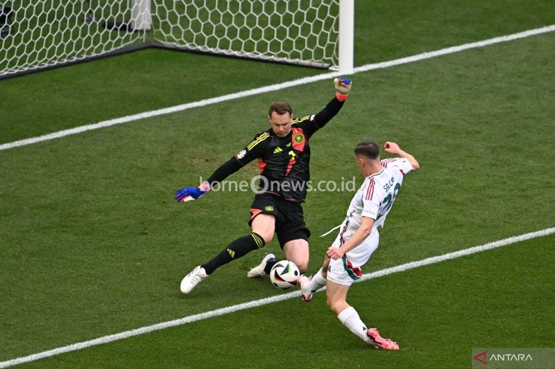 Penjaga gawang Jerman #01 Manuel Neuer mencegah penyerang Hongaria #20 Roland Sallai mencetak gol selama pertandingan sepak bola Grup A UEFA Euro 2024 antara Jerman dan Hongaria di Stuttgart Arena di Stuttgart pada Rabu (19/6/2024). (ANTARA/AFP/Fabrik Coffrini)