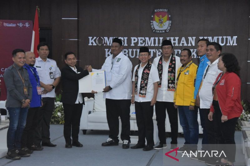 Ketua Tim Pemenangan pasangan calon bupati dan wakil bupati Dani Ramdan-Romli Muhamad Rochadi menyerahkan berkas pendaftaran kepada Ketua KPU Kabupaten Bekasi Ali Rido, Kamis. (ANTARA/Pradita Kurniawan Syah).