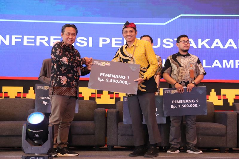 Sony Pawoko S Sos MTI (kemeja kuning) saat menerima mock up hadiah. ANTARA/Humas UI.