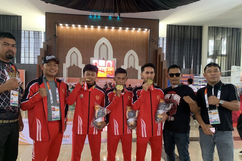 Tiga atlet Aceh bersama ofisial menggigit medali emas yang mereka raih dari kategori Muay Aerobic Putra cabor Muaythai yang diserahkan di Bale Meuseuraya Aceh (BMA) Kota Banda Aceh, Minggu (8/9/2024).ANTARA/Mario Sofia Nasution