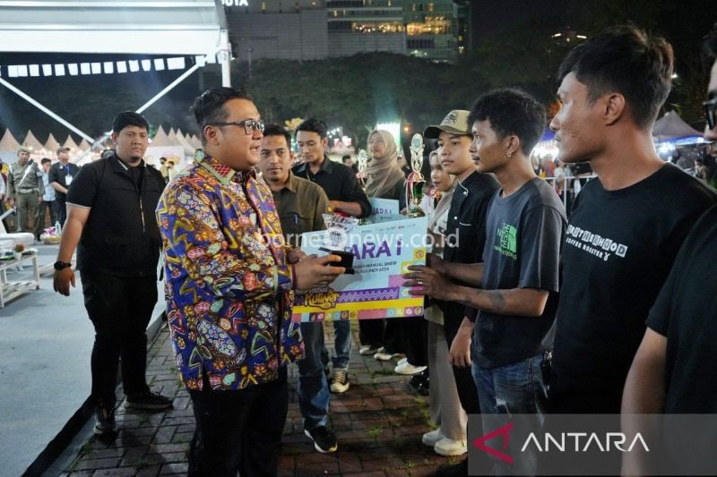 Pj Sekda Kota Medan Topan Obaja Putra Ginting (kiri) menyerahkan penghargaan sejumlah UMKM mengikuti Festival Kuliner Medan 2024, di Lapangan Benteng Medan, Sabtu (14/9/2024. (ANTARA/HO-Diskominfo Kota Medan)