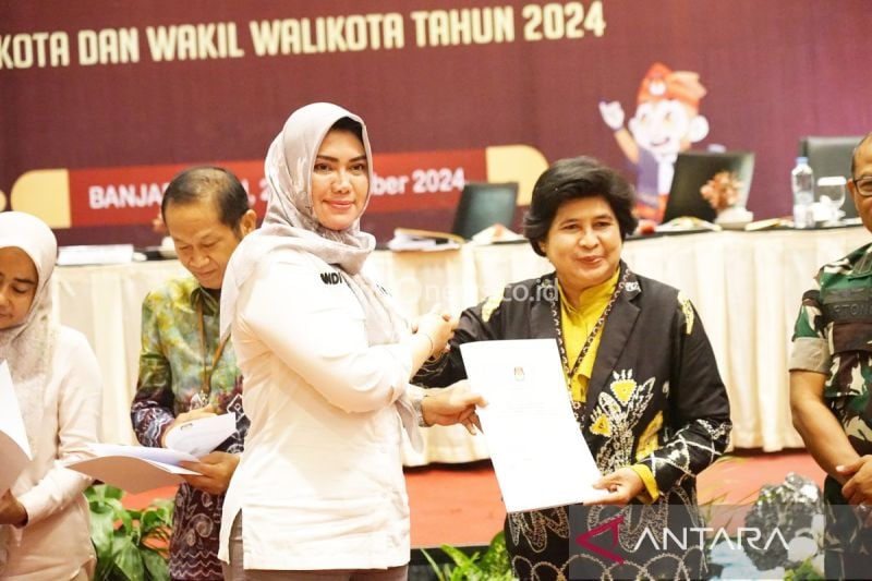 Ketua KPU Kalsel Andi Tenri Sompa menyerahkan berita acara DPT kepada Kasubdit VIP Dit Pamobvit Polda Kalsel AKBP Nina Rahmi yang mengikuti rapat pleno terbuka rekapitulasi DPT tingkat Provinsi Kalsel pada Pilkada 2024 di Banjarmasin, Minggu (22/9/2024). (ANTARA/Firman)