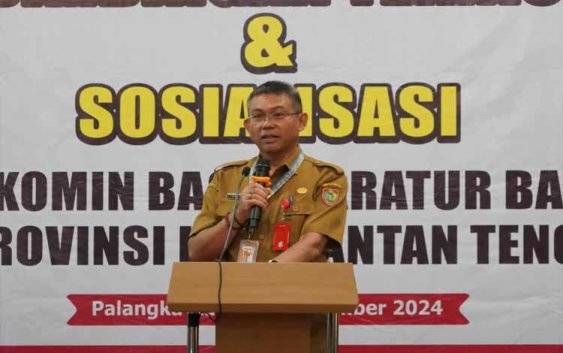 Plh Sahli Gubernur Bidang Pemkumpol Akhmad Husain bacakan sambutan. (FOTO:RINTO)
