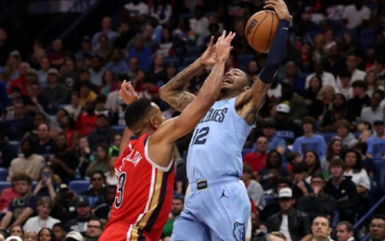 Pemain Memphis Grizzlies, Ja Morant (kanan) bertarung mempertahankan bola dari pemain New Orleans Pelicans, CJ McCollum, dalam laga NBA di Smoothie King Center, New Orleans, Louisiana. (ANTARA/AFP/CHRIS GRAYTHEN)