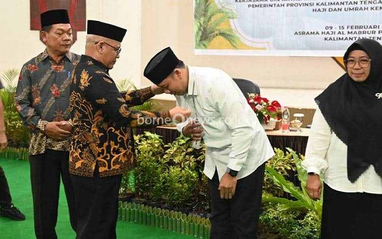 Pengalungan tanda peserta oleh Kepala Kantor Wilayah Kementerian Agama Kalteng, H Noor Fahmi. (FOTO: TOMY)