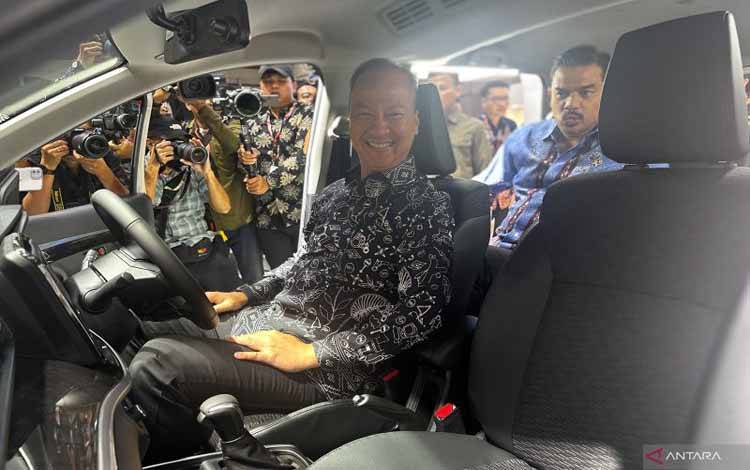 Menteri Perindustrian Agus Gumiwang Kartasasmita menjajal masuk ke dalam kabin salah satu mobil yang dipamerkan di Indonesia International Motor Show (IIMS) 2025, di JIExpo Kemayoran, Jakarta, Kamis (13/2/2025). (ANTARA/Pamela Sakina)