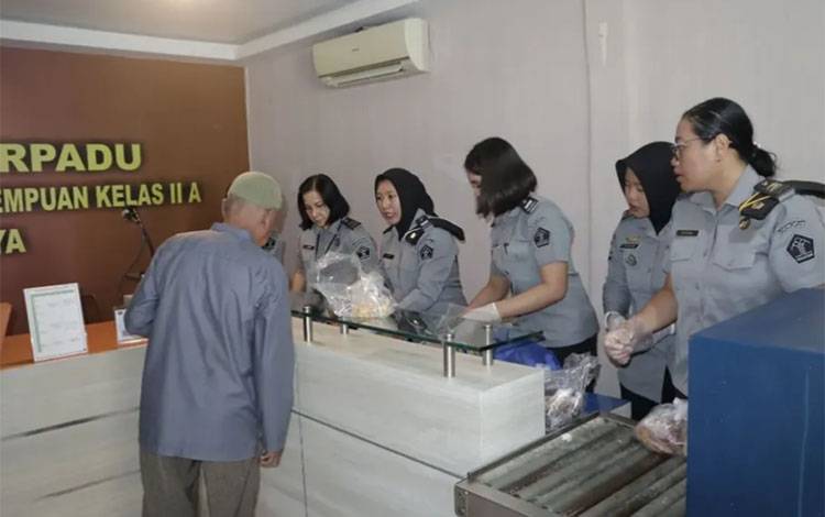 Petugas Lapas Kelas II A Palangka Raya saat memeriksa barang bawaan pengunjung (Foto : IST)