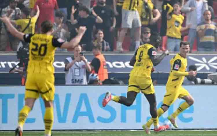 Penyerang Borussia Dortmund Serhou Guirassy (tengah) merayakan golnya ke gawang Bayer Leverkusen pada laga pekan ke-33 Liga Jerman Bundesliga 2024-2025 di Stadion BayArena, Leverkusen, Minggu (11/5/2025). Dortmund memenangi pertandingan itu dengan skor 4-2. (ANTARA/AFP/Ina Fassbender)