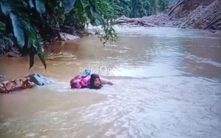 Seorang Bidan Nekat Arungi Sungai untuk Obati Pasien