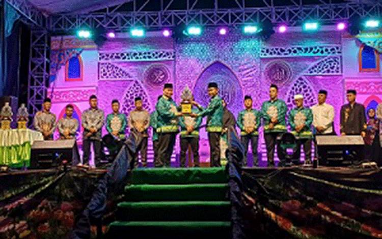 Camat Baamang Sufiansyah menerima piala MTQ dari Bupati Kotawaringin Timur Halikinnor simbol dimulainya MTQ ke-56, Sabtu, 27 September 2025. (FOTO: DEWIP)