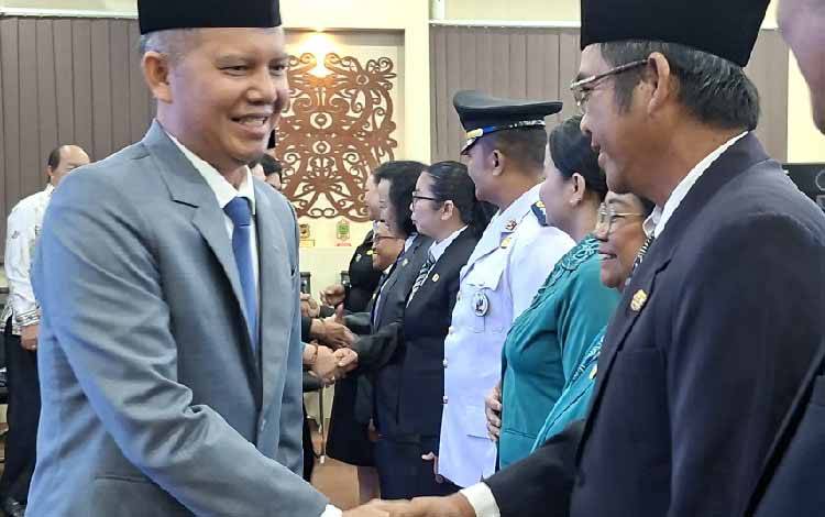 Bupati Gunung Mas Jaya S Monong saat bersalaman dengan pejabat administrator dan pejabat fungsional yang baru dilantik, Selasa, 9 Desember 2025 malam. (FOTO: RISKA YULYANA)