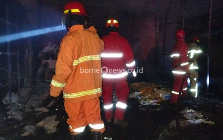 Anggota Damkar Kobar saat memeriksa lokasi gudang kabel milik PT KPC di Komplek Pelabuhan Tanjung Kalap, Kecamatan Kumai, Minggu malam, 11 Januari 2026.
