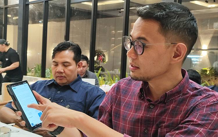 Kepala OJK Kalteng, Primandanu Febriyan Aziz menunjukkan laman pelaporan yang bisa diakses masyarakat jika terkendala kasus keuangan. (FOTO: TESTI PRISCILLA)